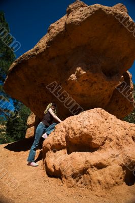 Woman posing under rock