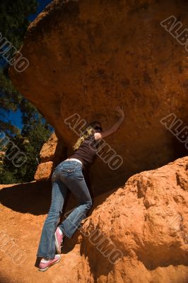 Woman posing under rock