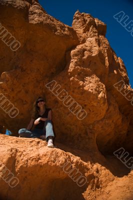 Woman posing under rock