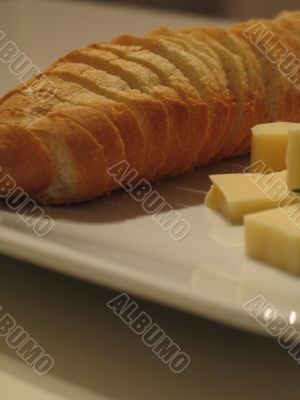 Bread and cheese on a white plate close-up