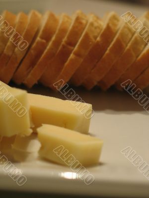 Bread and cheese on a white plate close-up