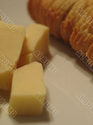 Bread and cheese on a white plate close-up