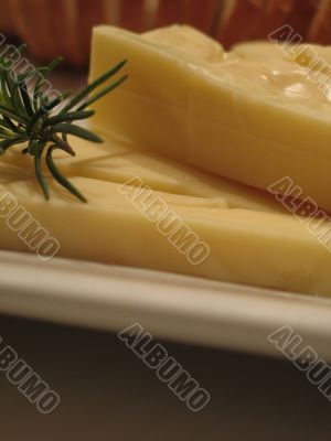 Bread and cheese on a white plate close-up