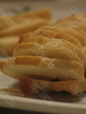 Bread and cheese on a white plate close-up