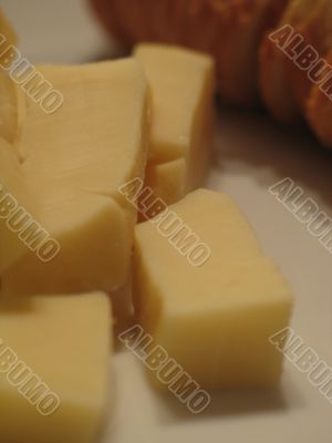 bread and cheese on a white plate close-up