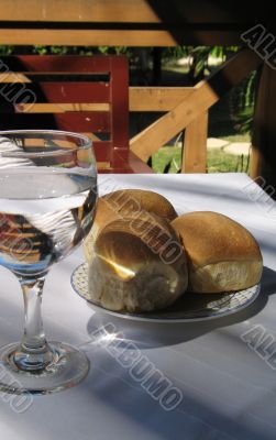 bread and water on a restaurant table