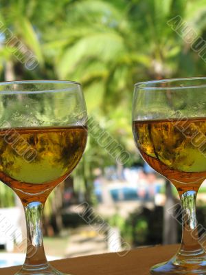 two full beer glasses by the pool
