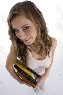 young student with books looking upward