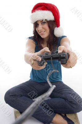 young woman with remote and christmas hat