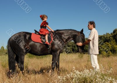 father, daughter and horse