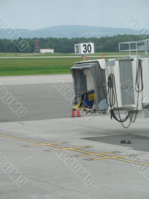 empty airplane gate with small trucks