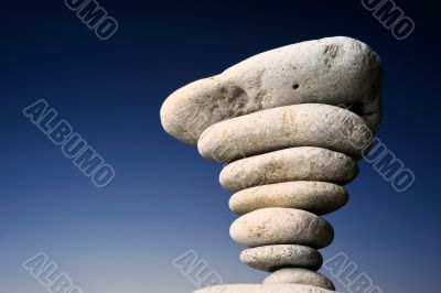 Stack of pebbles against blue
