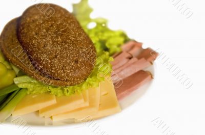 plate with slice of ham and cheese