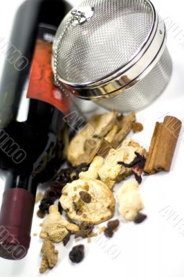 wine, dried fruits, spices and metal strainer
