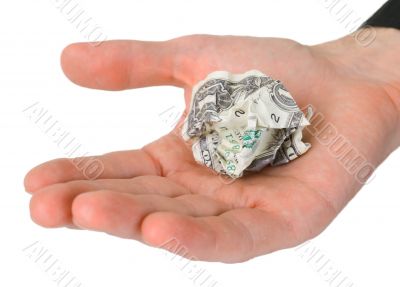 Male hand holding crumpled dollar
