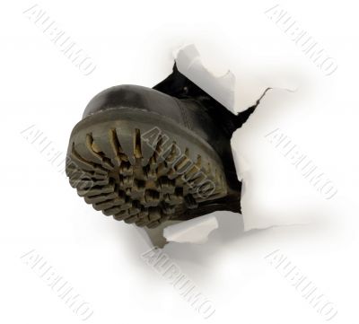 Male black boot in hole of paper