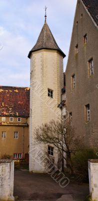 Old light stone tower in the yard the lock