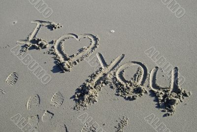 I love you inscription on a sand beach