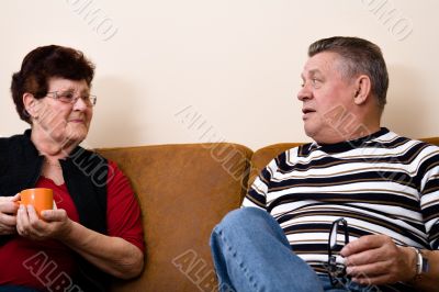 Senior couple drinking cofee and talking