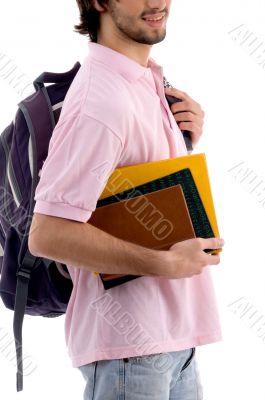 young man holding bag and books