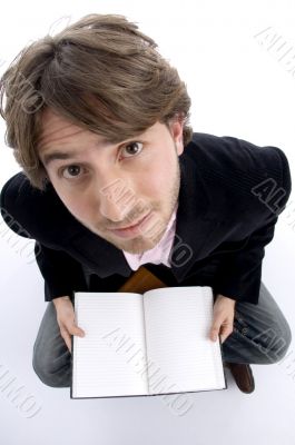 man holding notebook and looking upward