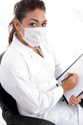 sitting doctor with mask and writing board