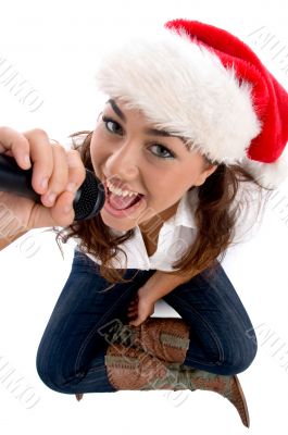 young pretty wearing christmas hat and singing
