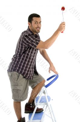 young guy holding painting brush