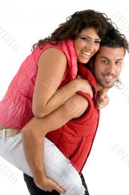 woman riding piggy back on man