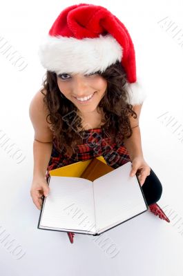 smiling student with christmas hat and books