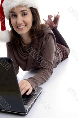 female lying on floor working on laptop