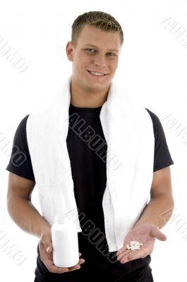 man holding bottle and pills