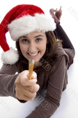 young student in christmas hat showing her pencil