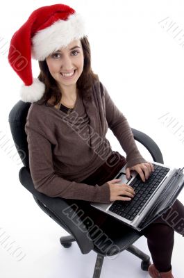 happy teenager busy with laptop looking at camera