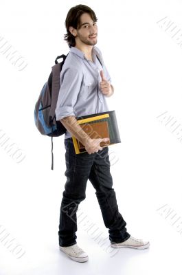 full body pose of student holding his books