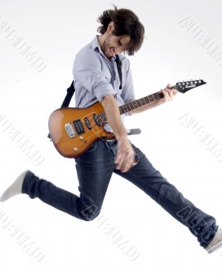 smart fellow jumps while playing guitar