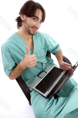 doctor working on laptop wishing goodluck