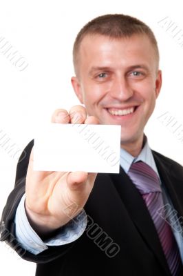 smiling young businessman holding a blank business card