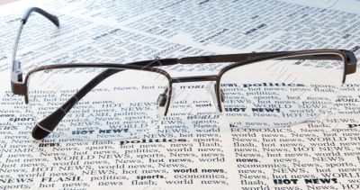 glasses above a newspaper