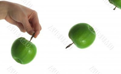 The thrown green tasty-looking apple from hand