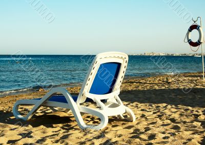 Deck-chair next  to the sea.