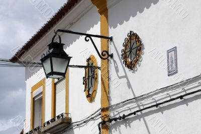 House with yellow decoration, street lamp and Madonna