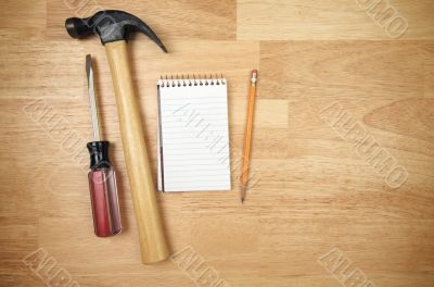 Pad of Paper, Pencil, Hammer and Screwdriver