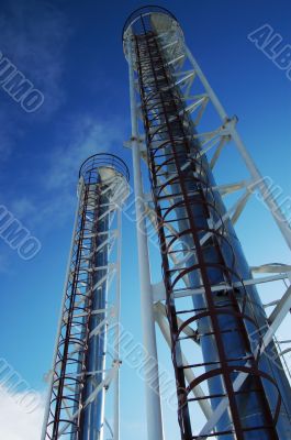 Industrial pipes and ladders on the blue sky