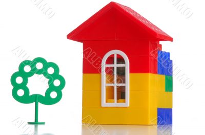 construction of a house, and green tree