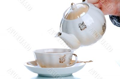 flowing tea into cup