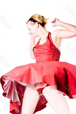 Funny girl in red gala dress dancing