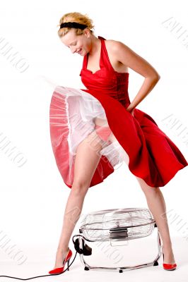 Funny girl in red gala dress standing over a ventilator