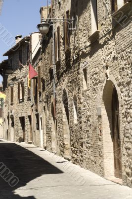 Bevagna - Ancient street with red and yellow flags