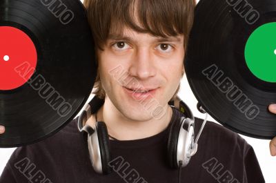 Young man with a headphones and vinylic disc.